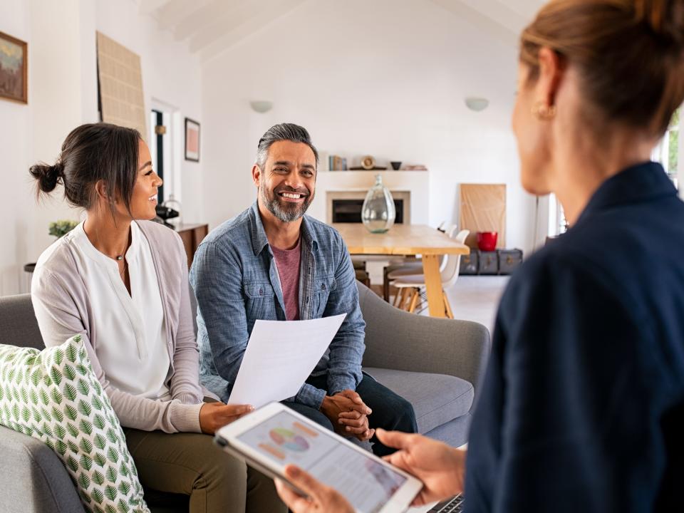 Couple talking to financial advisor.