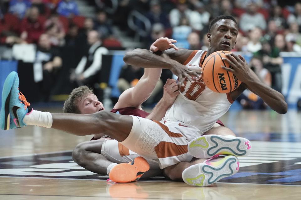 Texas' Sir'Jabari Rice and Colgate's Tucker Richardson battle for a loose ball during the second half of a first-round college basketball game in the NCAA Tournament Thursday, March 16, 2023, in Des Moines, Iowa. (AP Photo/Morry Gash)