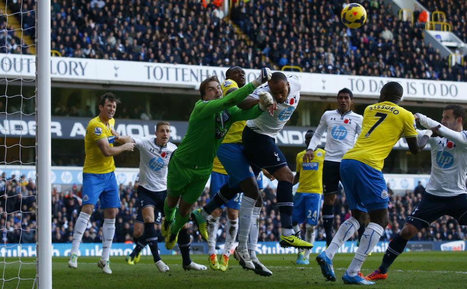 Newcastle United's Tim Krul (3rd L) punches the ball clear from Tottenham Hotspur's Younes Kaboul (5th L) during their English Premier League soccer match at White Hart Lane in London November 10, 2013.