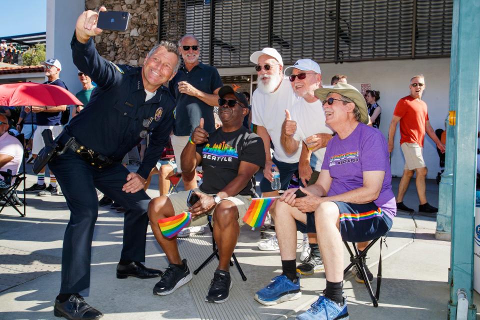 Palm Springs Police Chief Andrew Mills takes a selfie with paradegoers during the Greater Palm Springs Pride Parade in downtown Palm Springs, Calif., on Sunday, Nov. 6, 2022.