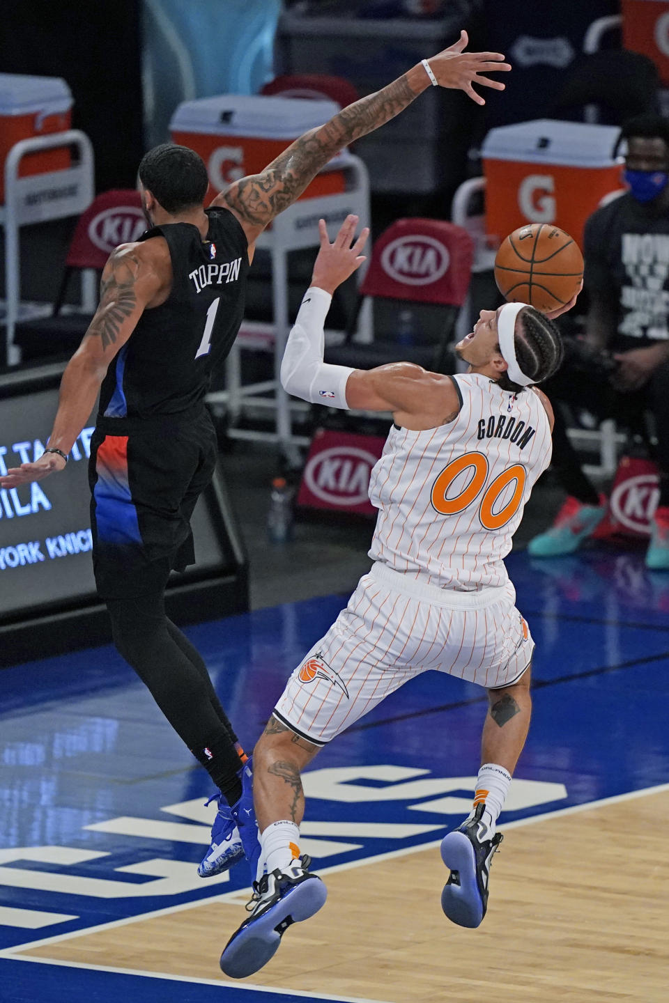 New York Knicks forward Obi Toppin (1) defends Orlando Magic forward Aaron Gordon (00) during the first half of an NBA basketball game, Monday, Jan. 18, 2021, in New York. (AP Photo/Kathy Willens, Pool)