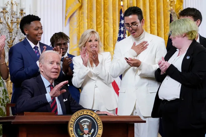 Youth activist Javier Gomez reacts after President Joe Biden handed him a pen he used to sign an executive order at an event to celebrate Pride Month in the East Room of the White House, Wednesday, June 15, 2022, in Washington.