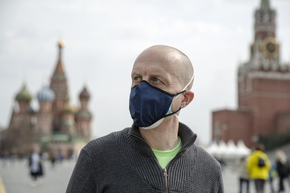 Uwe Keim wearing a face mask to protect against coronavirus walks in Red square after getting the first shot of Russia's Sputnik V coronavirus vaccine in Moscow, Russia, Friday, April 16, 2021. Keim, 46-year-old software developer from Stuttgart, told The Associated Press after getting his jab that he isn't worried about depriving some Russian of their shot, as he believes "there are more vaccines available here in Russia than is demanded by the people here." (AP Photo/Pavel Golovkin)