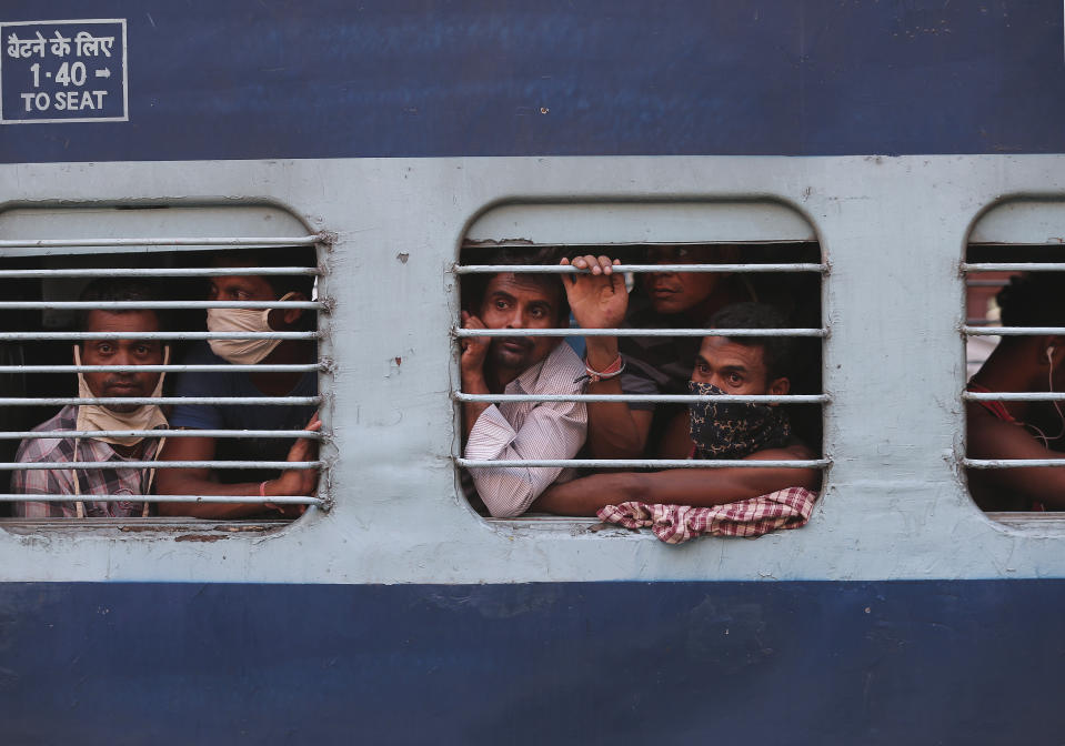 Migrant workers look out a train window before moving to their home states, at Hyderabad Railway Station in Hyderabad, India, Saturday, May 23, 2020. India's lockdown was imposed on March 25 and has been extended several times. On May 4, India eased lockdown rules and allowed migrant workers to travel back to their homes, a decision that has resulted in millions of people being on the move for the last two weeks. (AP Photo/Mahesh Kumar A.)