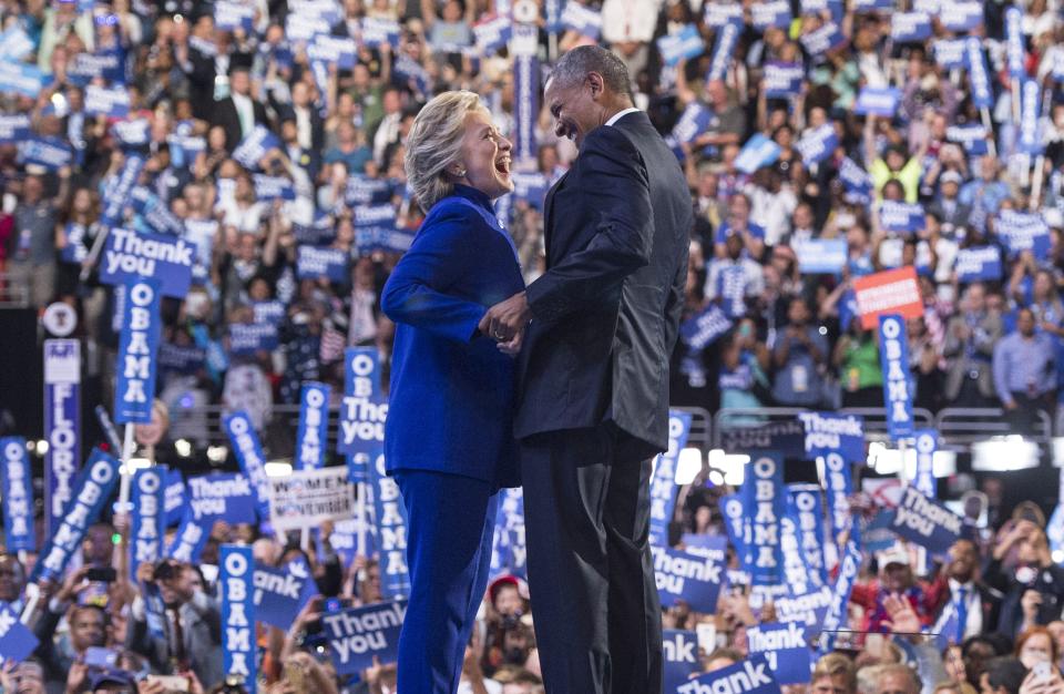 US President Barack Obama is joined by US Democratic presidential candidate Hillary Clinton after his address to the Democratic National Convention at the Wells Fargo Center in Philadelphia, Pennsylvania, July 27, 2016.