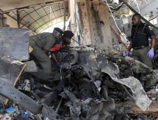 Police work at the site of a bombing in Abuja, Nigeria, on April 26. A blast went off outside a nightclub in the Nigerian capital late Friday, June 22, hours after the national security adviser and defence minister were sacked amid fears over spiralling violence in the country's north