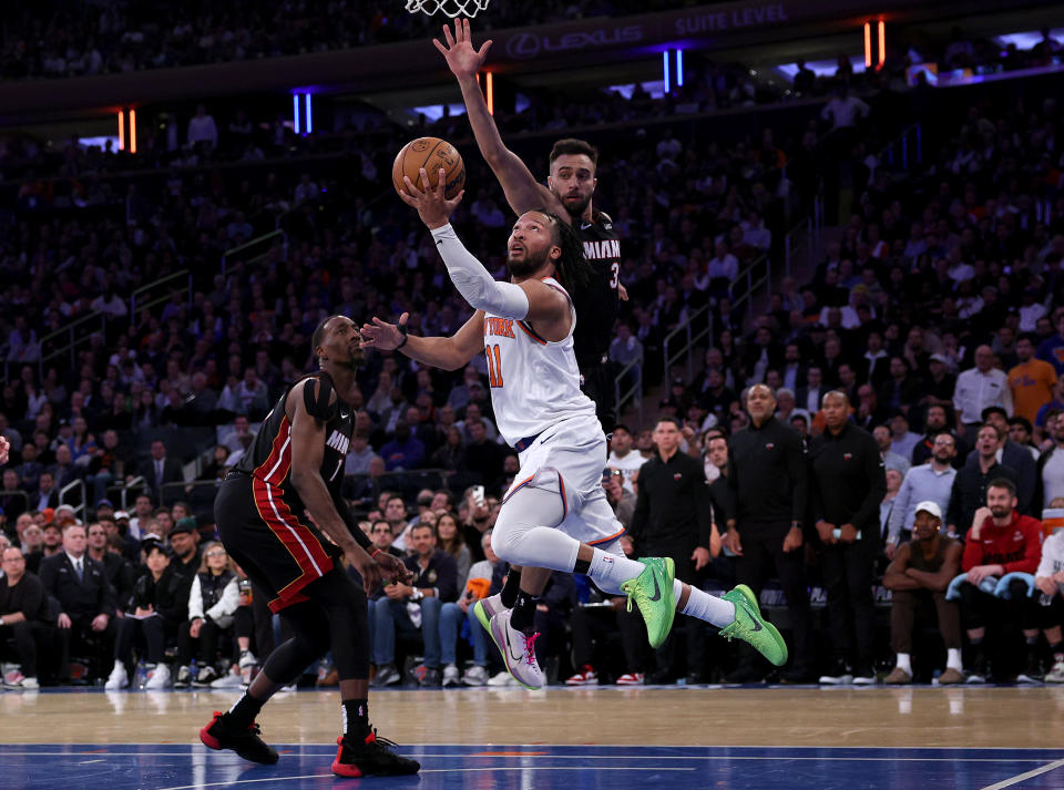 NEW YORK, NEW YORK - MAY 02:  Jalen Brunson #11 of the New York Knicks heads for the net as Bam Adebayo #13 and Max Strus #31 of the Miami Heat defend in the fourth quarter during game two of the Eastern Conference Semifinals at Madison Square Garden on May 02, 2023 in New York City. The New York Knicks defeated the Miami Heat 111-105. NOTE TO USER: User expressly acknowledges and agrees that, by downloading and or using this photograph, User is consenting to the terms and conditions of the Getty Images License Agreement. (Photo by Elsa/Getty Images)