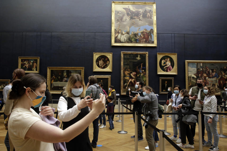 Image: People take snapshots as they visit the Louvre in Paris. (Thibault Camus / AP)