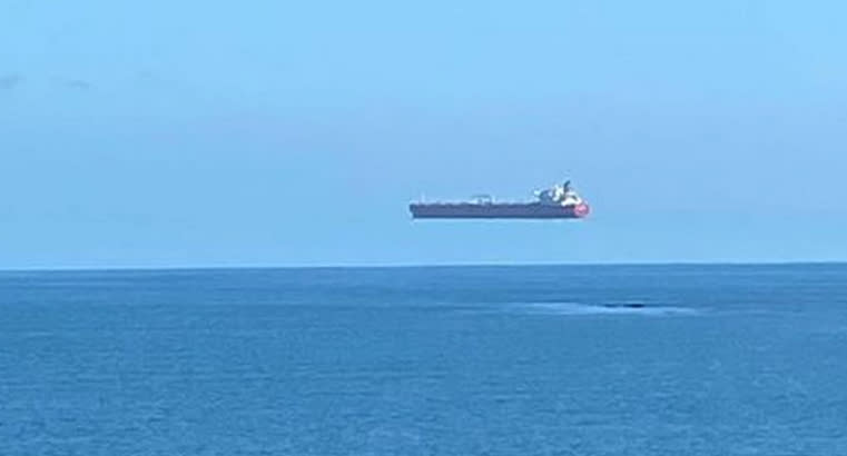 A ship appearing to float on thin air off the coast of Cornwall, England.