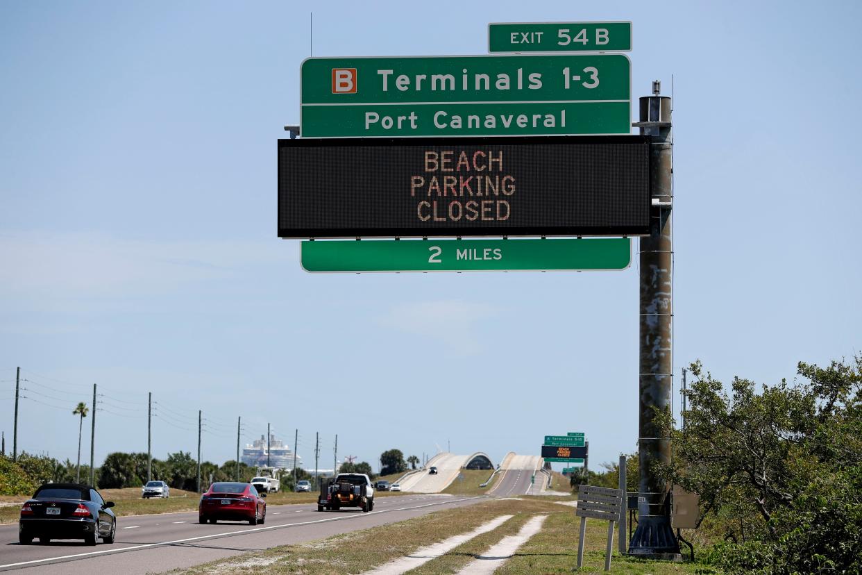 Informational signs near Port Canaveral warn motorists that all beach parking in Brevard County is closed Saturday, April 4, 2020, in Cape Canaveral, Fla. Although some county beaches remain open during the coronavirus outbreak, without parking many beachgoers remained at home.