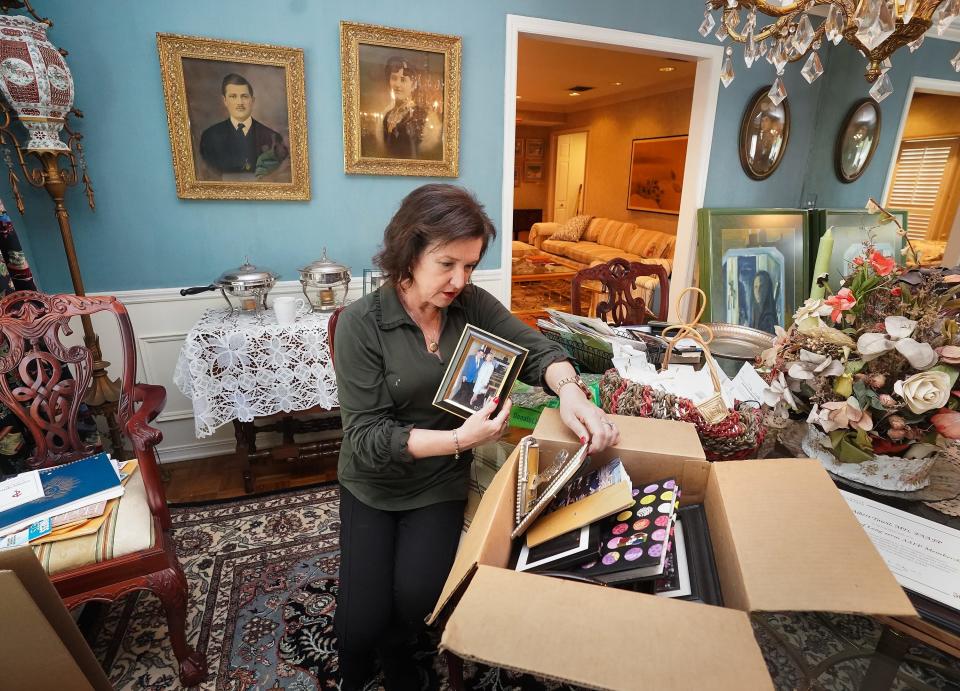 Lisa Tawil sorts through boxes of memories at her parent's house in Tampa on April 28, 2022.