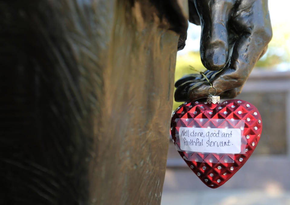 A heart ornament placed in tribute to former President George H.W. Bush hangs off a hand at the Bush monument in Houston on Dec. 1. (Photo: Thomas B. Shea/AFP/Getty Images)