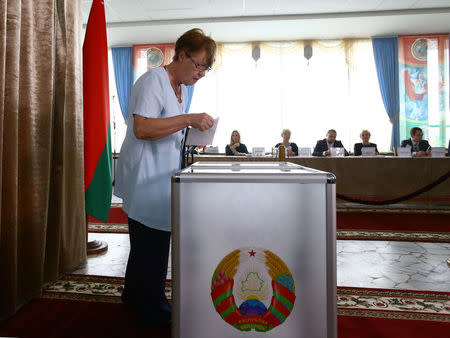 A woman casts her ballot during a parliamentary election at a polling station in Minsk, Belarus September 11, 2016. REUTERS/Vasily Fedosenko