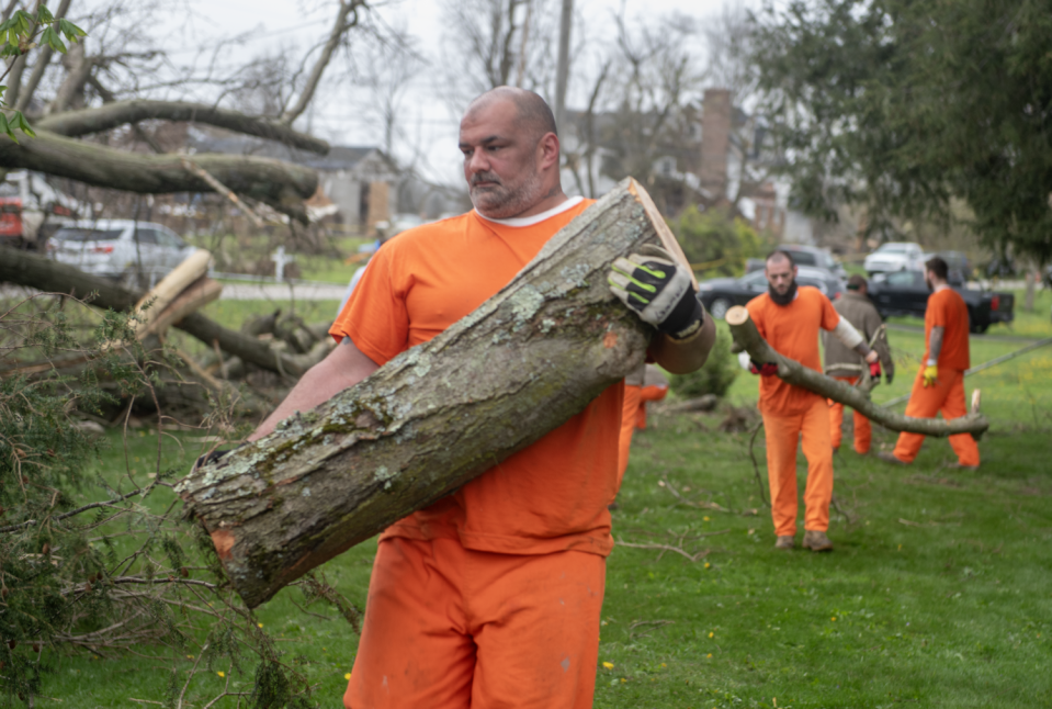 William Boyle, a Portage County Jail inmate, helps clear debris from a fallen tree Friday, April 19, 2024, at the Windham Cemetery. Lewis is part of the Inmate Training Program where nonviolent jail inmates can be chosen to work in Portage communities.
