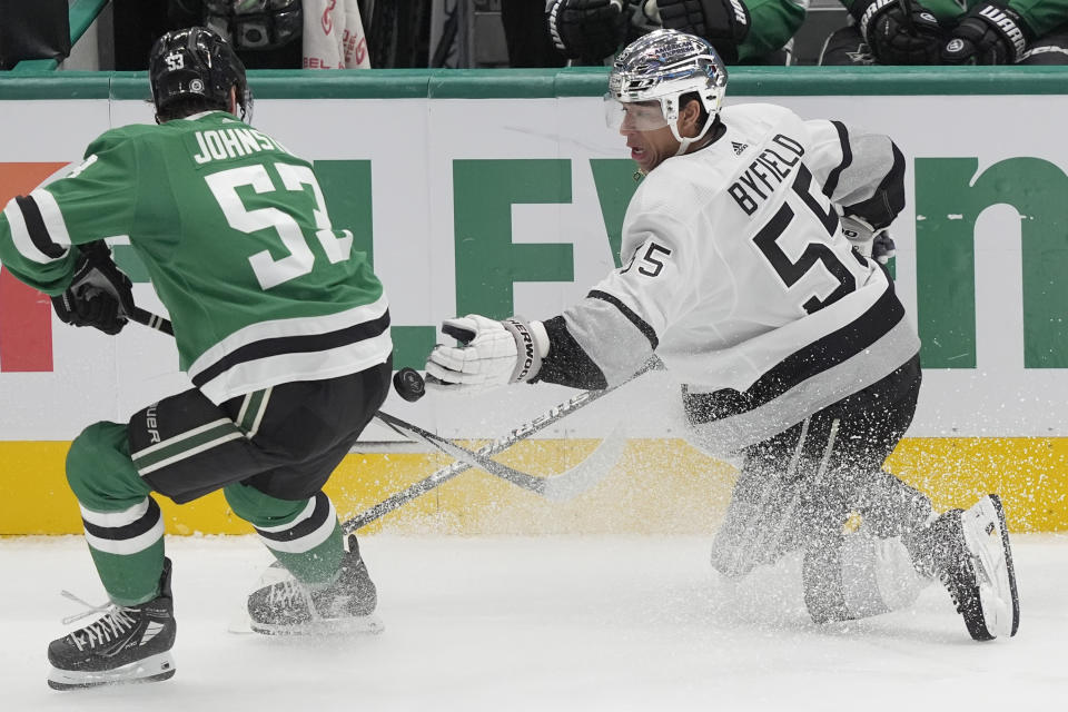 Los Angeles Kings right wing Quinton Byfield and Dallas Stars center Wyatt Johnston vie for control of the puck during the third period an NHL hockey game in Dallas, Saturday, March 16, 2024. (AP Photo/LM Otero)