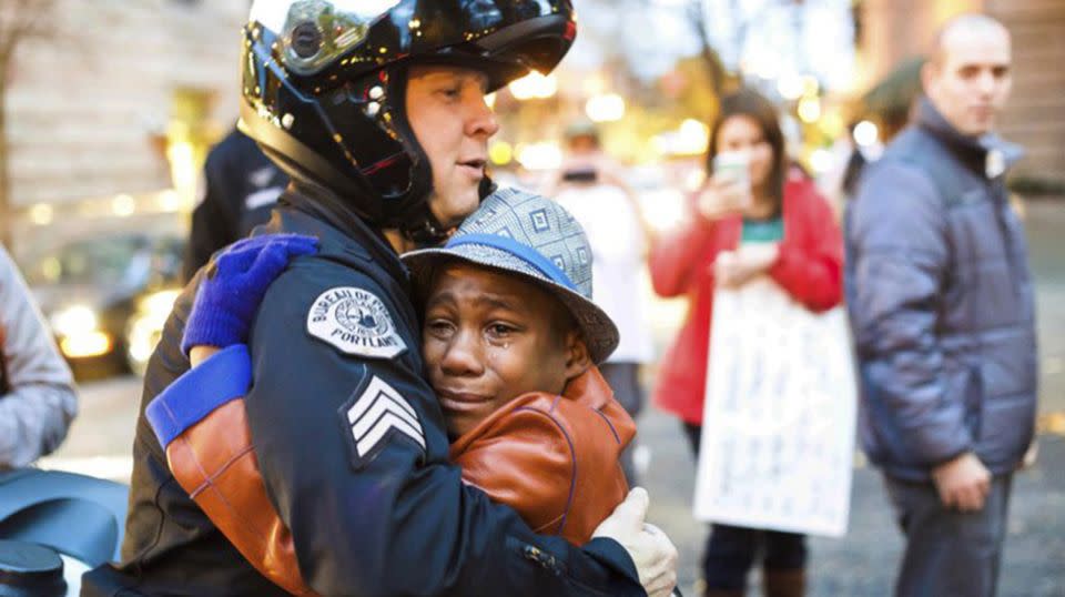 Devonte Hart gained fame when this picture of him hugging officer Johnny Nguyen at a Portland rally went viral. He is one of three children still missing after the vehicle went over the cliff. Source: AP