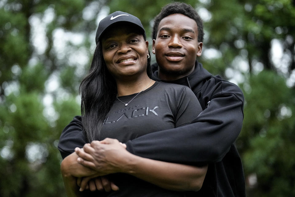 Janel Jones poses with her son, Christian Jones, 17, on Friday, May 17, 2024, in Lawrenceville, Ga. Jones, a divorced veteran in Atlanta with two children, said though she has seen the benefits of choice having sent her 13-year-old daughter and 17-year-old son to seven different schools combined across the country, she feels at though just giving parents an option is not enough. (AP Photo/Mike Stewart)