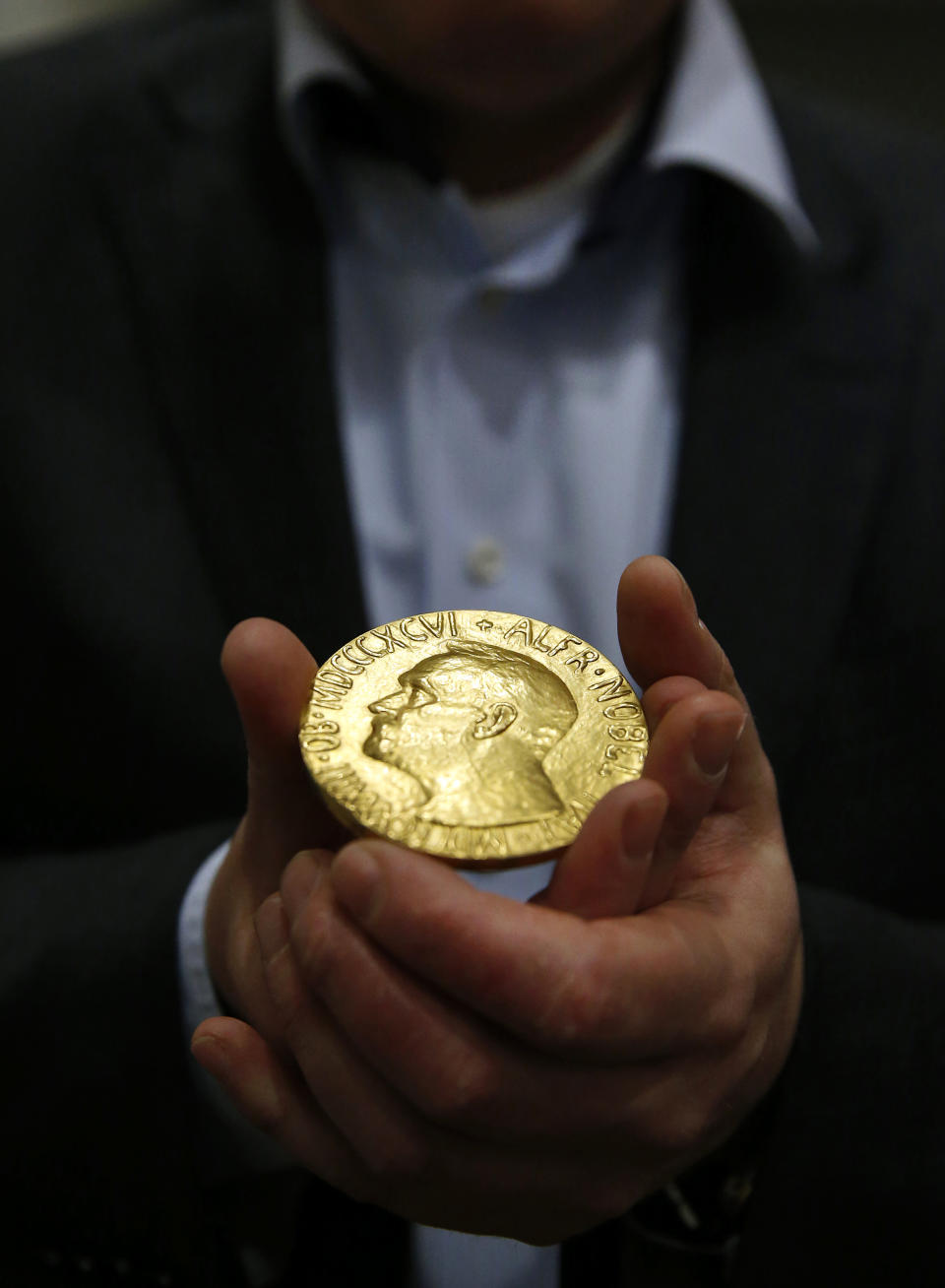 Bidder Ole Bjorn Fausa, of Norway, holds the 1936 Nobel Peace Prize medal in Baltimore, Thursday, March 27, 2014, the second Nobel Peace Prize ever to come to auction. The prize sold for a winning bid of $950,000 at auction, and an additional buyer’s commission brought the final sale price to $1.16 million. The recipient was Argentina's foreign minister, Carlos Saavedra Lamas, who was honored for his role in negotiating the end of the Chaco War between Paraguay and Bolivia. (AP Photo/Patrick Semansky)