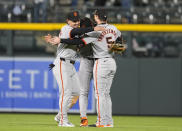 From left, San Francisco Giants left fielder Michael Conforto, center fielder Jung Hoo Lee and right fielder Mike Yastrzemski celebrate after a baseball game against the Colorado Rockies Tuesday, May 7, 2024, in Denver. (AP Photo/David Zalubowski)
