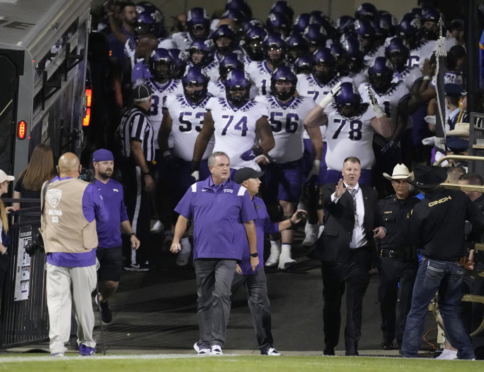 TCU coach Sonny Dykes leads the team onto the field for an NCAA college football game against Colorado on Friday, Sept. 2, 2022, in Boulder, Colo. (AP Photo/David Zalubowski)