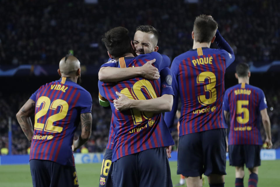 Barcelona's Lionel Messi, centre, is hugged by Jordi Alba after scoring his side's third goal during the Champions League round of 16, 2nd leg, soccer match between FC Barcelona and Olympique Lyon at the Camp Nou stadium in Barcelona, Spain, Wednesday, March 13, 2019. (AP Photo/Emilio Morenatti)