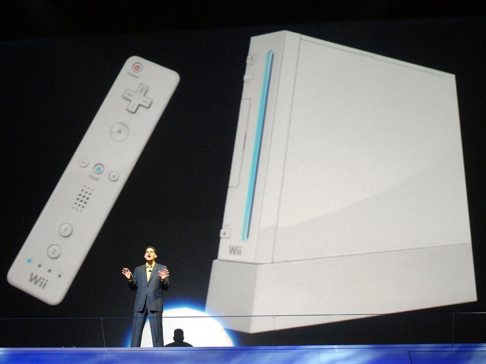 Reggie Fils-Aime, Nintendo of America's executive VP of sales and marketing, displays the Wii remote and console during the Nintendo media briefing.