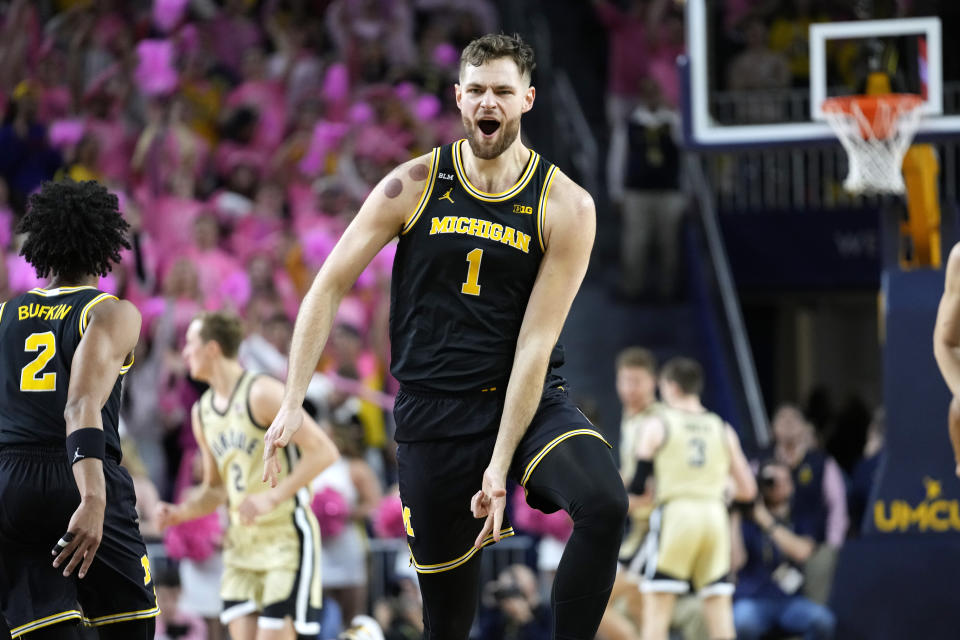 Michigan center Hunter Dickinson (1) celebrates after making a 3-point basket during the first half of an NCAA college basketball game against Purdue in Ann Arbor, Mich., Thursday, Jan. 26, 2023. (AP Photo/Paul Sancya)