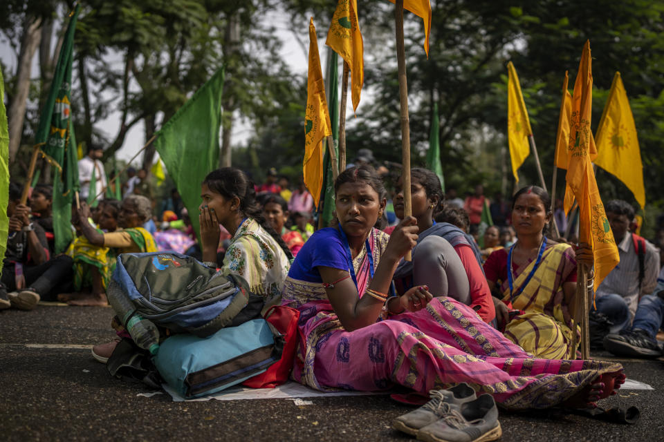 Tribes women sit on a highway as they listen to Salkhan Murmu, former lawmaker and community activist, during sit-in demonstration rally to demand of recognizing Sarna Dharma as a religion in Ranchi, capital of the eastern Indian state of Jharkhand, Oct. 18, 2022. Murmu, who also adheres to Sarna Dharma, is at the center of the protests pushing for government recognition of his religion. His sit-in demonstrations in several Indian states have drawn crowds of thousands. (AP Photo/Altaf Qadri)