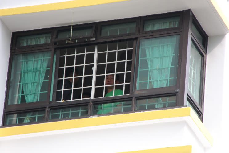 Suspect Tan Joo Soon Samuel (right) enacting the pellet shooting incident from his flat on the fifth floor at Blk 764A, Woodlands Avenue 6. Photo: Nigel Chin/Yahoo News Singapore