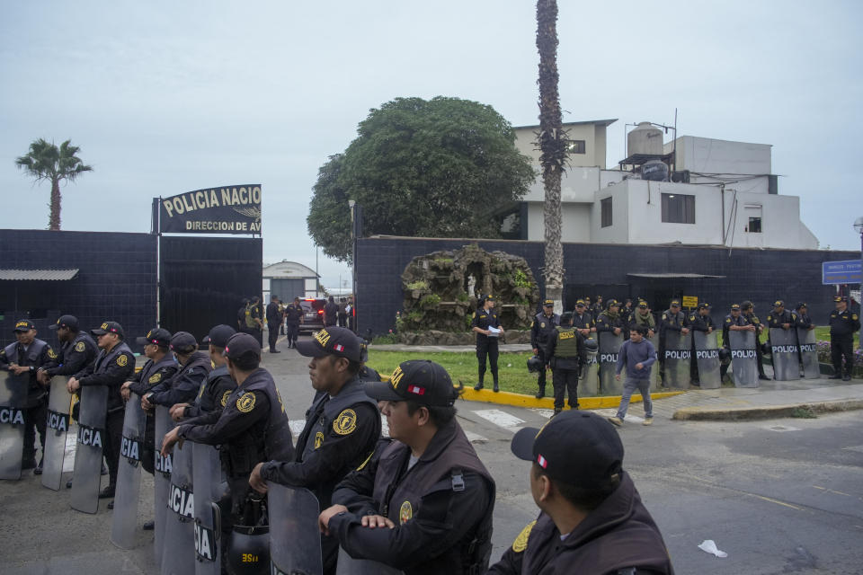 Police guard the entrance to the police terminal next to the international airport from where Peru's former President Alejandro Toledo will be taken to a detention facility after arriving in Lima, Peru, extradited from the United States, Sunday, April 23, 2023. Toledo will face charges for allegedly receiving bribes from the Brazilian construction company Odebrecht in return for awarding public works contract while in office between 2001 and 2006. (AP Photo/Guadalupe Pardo)