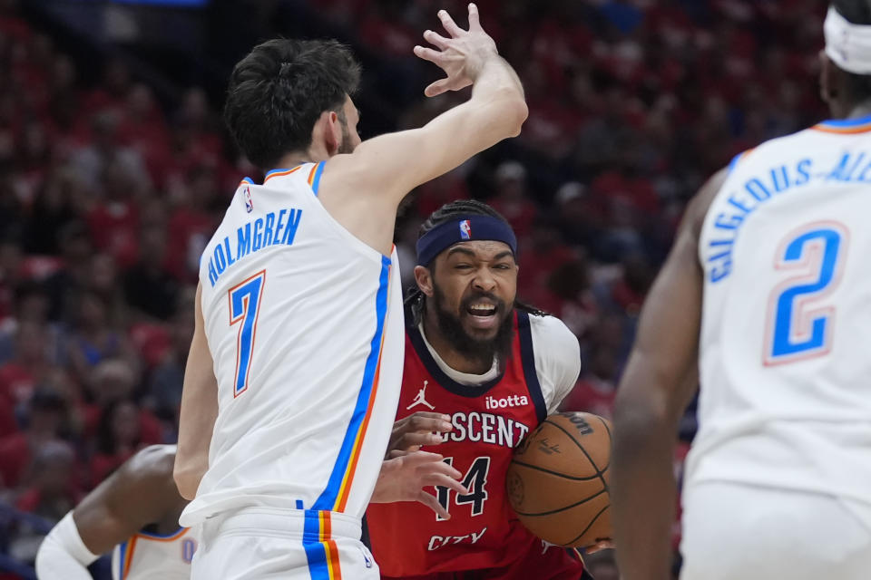 New Orleans Pelicans forward Brandon Ingram (14) drives to the basket agsaint Oklahoma City Thunder forward Chet Holmgren (7) in the first half of Game 3 of an NBA basketball first-round playoff series in New Orleans, Saturday, April 27, 2024. (AP Photo/Gerald Herbert)