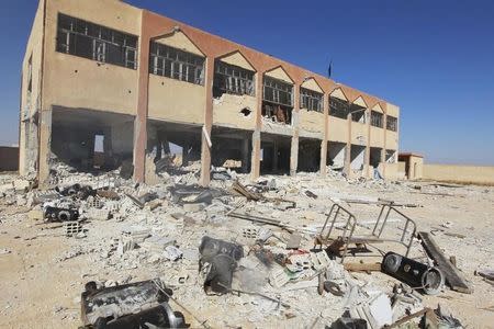 A damaged school building, which was used by Kurdish fighters as a base, is seen in al-Aziza village in the countryside of the Syrian Kurdish town of Kobani, after the Islamic State fighters took control of the area October 7, 2014. REUTERS/Stringer