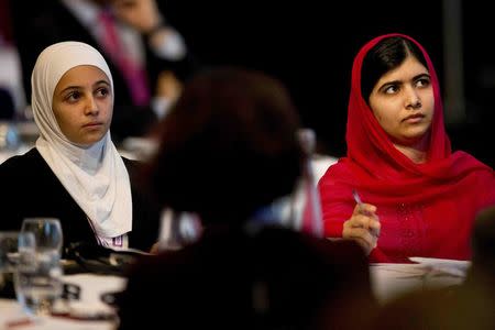 Nobel Peace Prize winner Malala Yousafzai (R) and 17-year-old Syrian refugee Mazoun Almellehan listen to speakers during the first focus event on education at the donors Conference for Syria in London, Britain February 4, 2016. REUTERS/Matt Dunham/pool