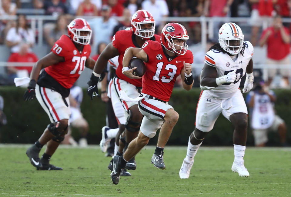 Georgia quarterback Stetson Bennett breaks away for a 60-plus yard touchdown run on a quarterback keeper against Auburn during the second half of an during an NCAA college football game, Saturday, Oct. 8, 2022, in Athens, Ga. (Curtis Compton/Atlanta Journal-Constitution via AP)