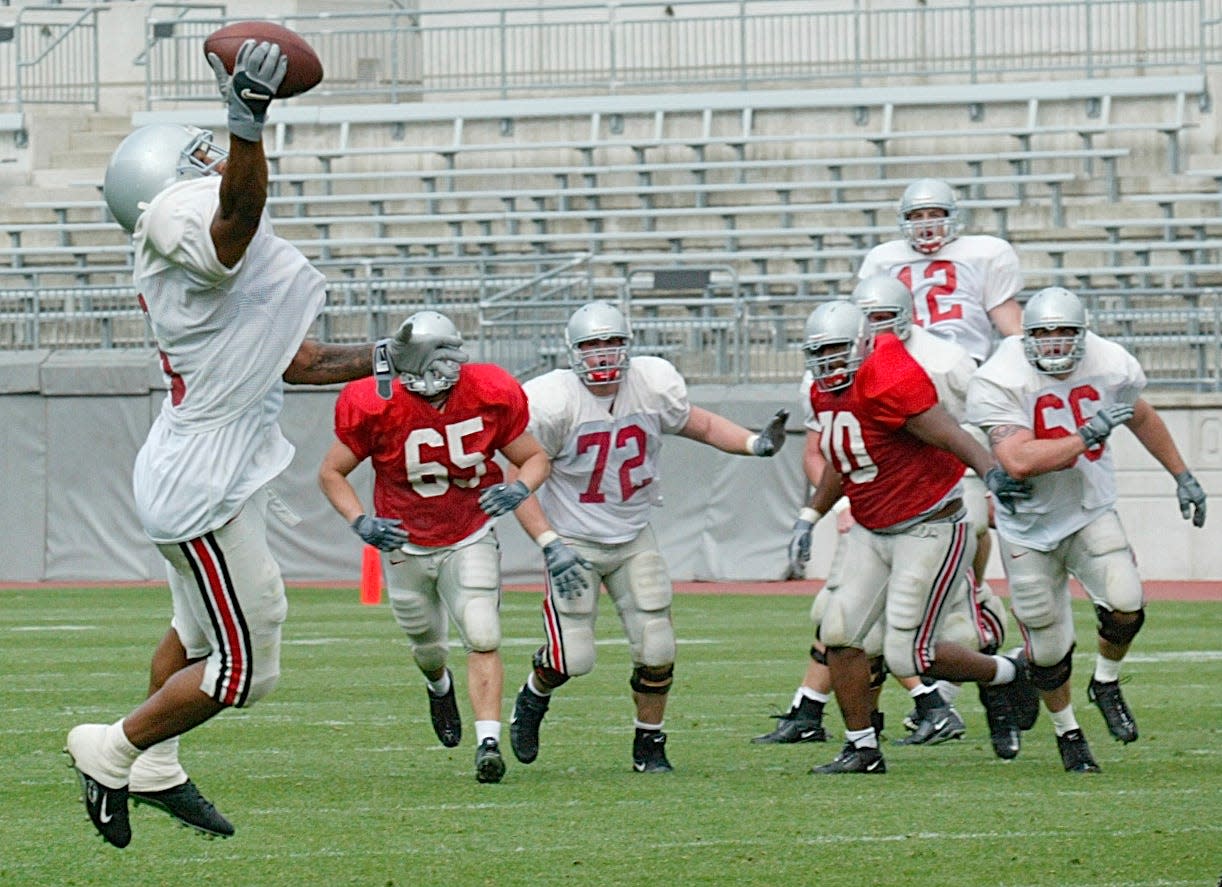 Ohio State's Bam Childress makes a one-handed reception from teammate Justin Zwick during the team's scrimmage at Ohio Stadium on April 17, 2004.