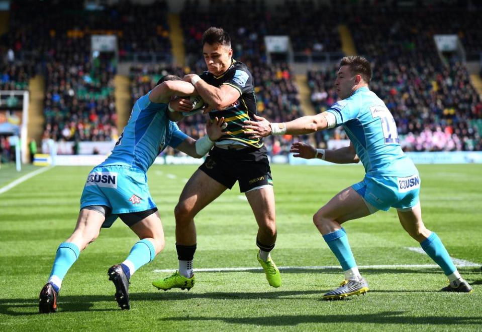 Northampton’s Tom Collins tries to escape the attentions of two Worcester defenders.