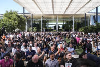 People attend an Apple event announcing new products in Cupertino, Calif., Monday, June 10, 2024. (AP Photo/Jeff Chiu)