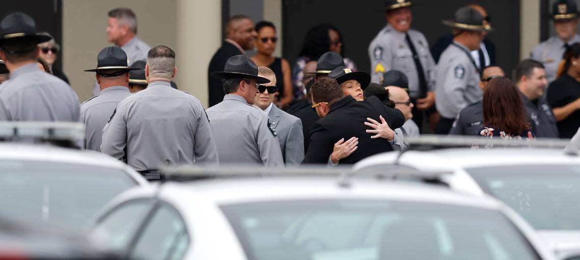 Attendees hug before the funeral for slain Wake County Sheriffs Deputy Ned Byrd at Providence Baptist Church in Raleigh, N.C., Friday, August 19, 2022.