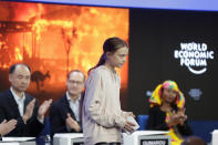 Panel members applaud for Swedish environmental activist Greta Thunberg after she addressed guests at the World Economic Forum in Davos, Switzerland, Tuesday, Jan. 21, 2020. The 50th annual meeting of the forum will take place in Davos from Jan. 21 until Jan. 24, 2020. (AP Photo/Michael Probst)