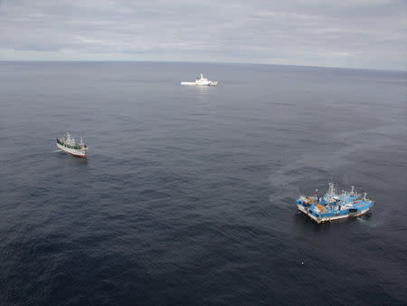 South Korean trawlers are seen along with Japanese fishing ship Shotoku-Maru No. 38 (L) and Japan Coast Guard patrol vessel Bukou (C), after a South Korean trawler and the Japanese fishing boat collided in the Sea of Japan, in this handout photo taken November 15, 2018 and provided by Japan Coast Guard. 9th Regional Coast Guard Headquarters - Japan Coast Guard/Handout via REUTERS