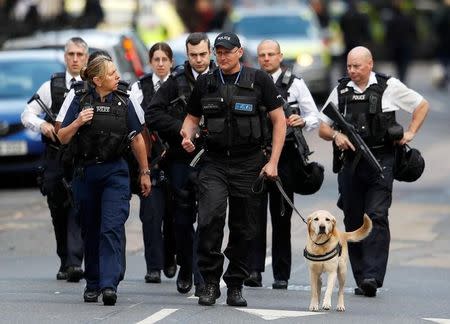 Armed police officers walk outside Borough Market after an attack left 6 people dead and dozens injured in London, Britain, June 4, 2017. REUTERS/Peter Nicholls