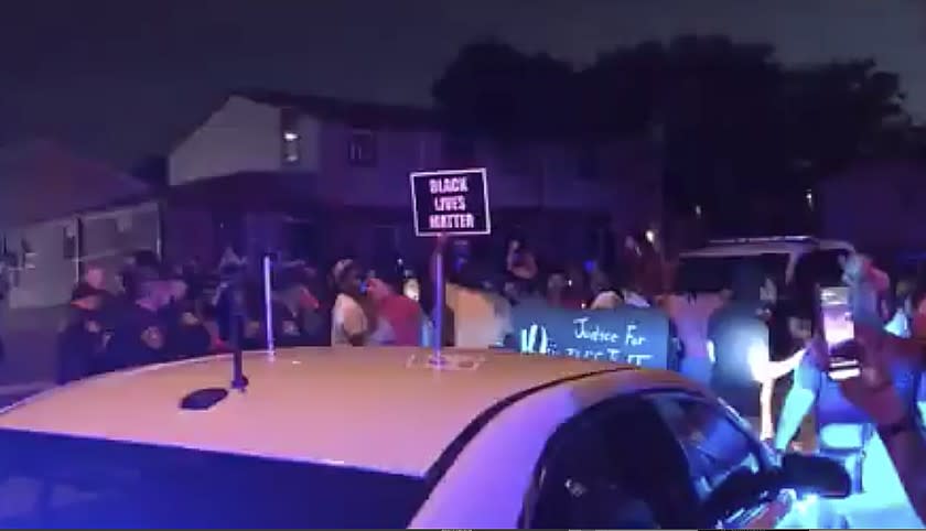 In this image made from video, protesters gather near the site of a police shooting, Sunday, Aug. 23 in Kenosha, Wis.