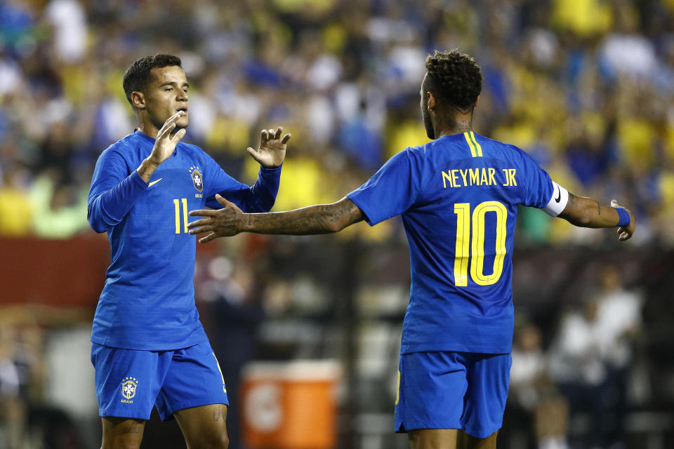 Brazil forward Philippe Coutinho, left, celebrates his goal with teammate Neymar in the first half of a soccer match against El Salvador, Tuesday, Sept. 11, 2018, in Landover, Md. (AP Photo/Patrick Semansky)