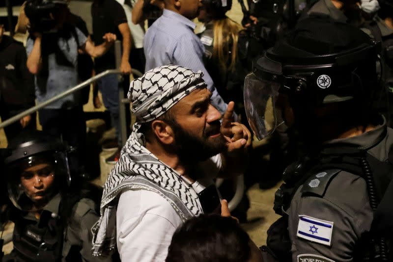 FILE PHOTO: A Palestinian man gestures as he argues with an Israeli border policeman by the entrance to Jerusalem's Old City