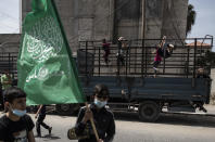 Palestinian children swing on the back of a truck as Hamas supporters attend a protest in solidarity with Muslim worshippers in Jerusalem, in Gaza City, Friday, April. 23, 2021. (AP Photo/Khalil Hamra)