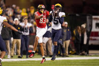 Michigan defensive back DJ Turner (5) intercepts a pass intended for Maryland wide receiver Carlos Carriere during the first half of an NCAA college football game, Saturday, Nov. 20, 2021, in College Park, Md. Michigan won 59-18. Turner return the interception for a touchdown. (AP Photo/Julio Cortez)