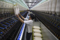 A worker labors at the Wenzhou Tiancheng Textile Company, one of China's largest cotton recycling plants in Wenzhou in eastern China's Zhejiang province on March 20, 2024. (AP Photo/Ng Han Guan)