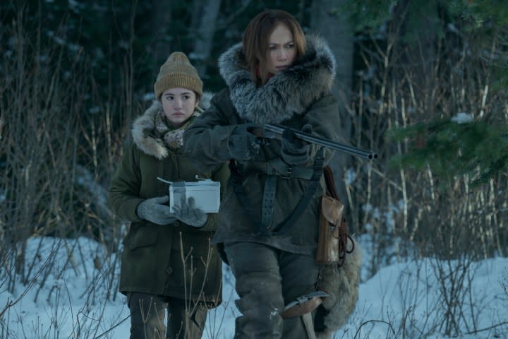 Two women walk through snow in The Mother.