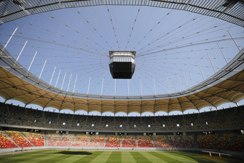 FILE - In this Sunday, April 25, 2021 filer, the video display casts a shadow on the pitch of the National Arena stadium, a venue of the Euro 2020 soccer tournament, in Bucharest, Romania. For players, the pandemic has meant a congested season that poses fitness challenges, let alone trying to avoid coronavirus infections. Financially playing the delayed tournament is essential for UEFA. For fans, the EURO 2020 24-team event should be the first chance for the widespread return of fans to stadiums across Europe since March 2020, assuming new restrictions aren't imposed. (AP Photo/Vadim Ghirda, File)