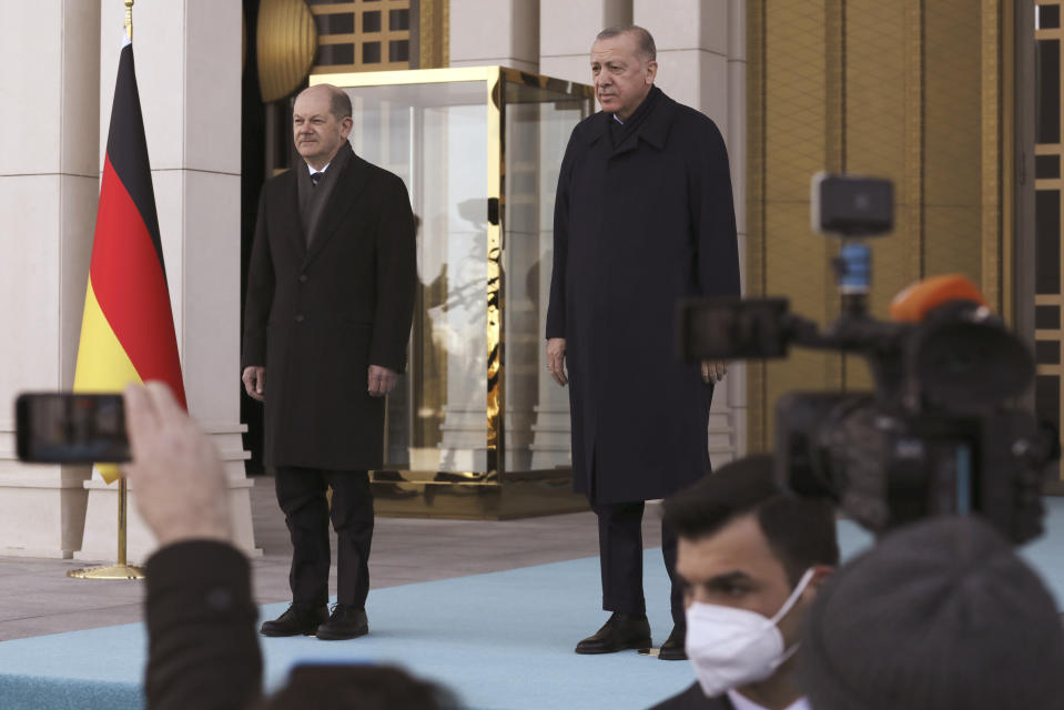 Turkish President Recep Tayyip Erdogan, right, and Germany's Chancellor Olaf Scholz stand during a ceremony in Ankara, Turkey, Monday, March 14, 2022. Scholz is visiting Turkey Monday in his first official trip to the country since he took office in December. He will hold talks with Turkish President Recep Tayyip Erdogan in Ankara.(AP Photo/Burhan Ozbilici)